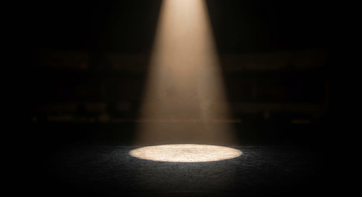 A spotlight on a dark stage representing the narrow focus of working memory capacity